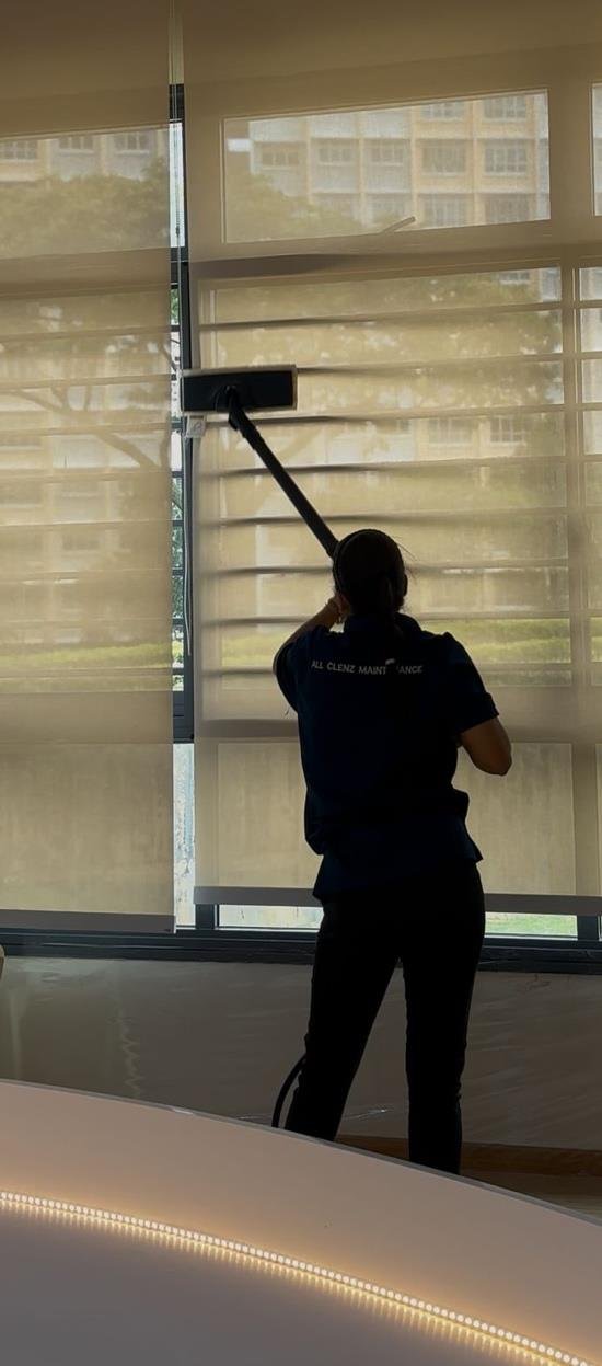 ACM crew cleaning windows in a modern commercial building