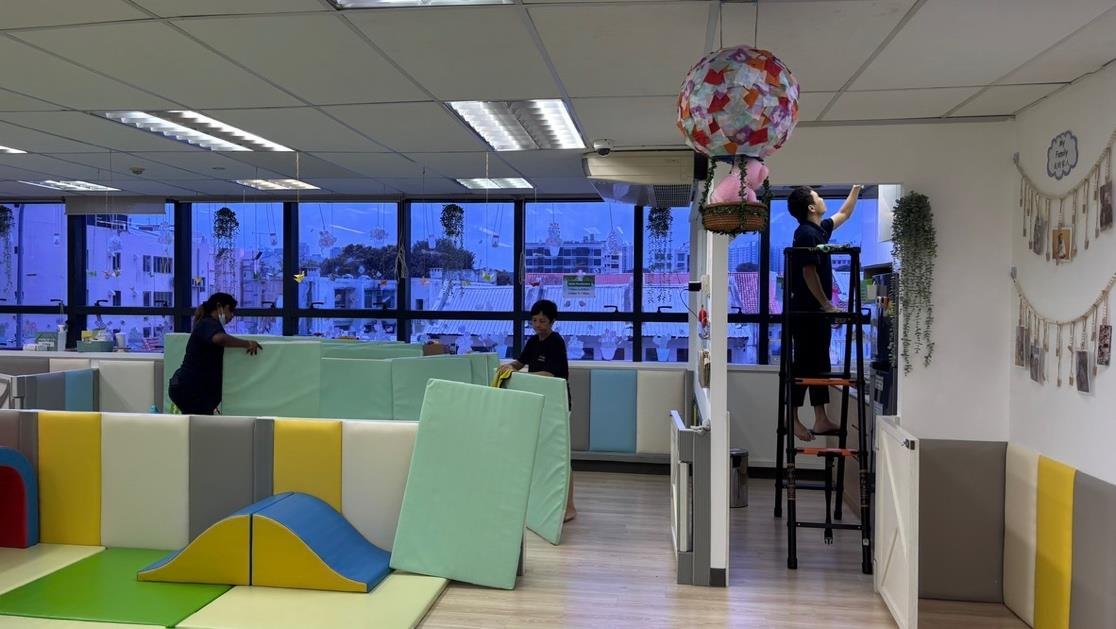 ACM cleaners working in a commercial office space